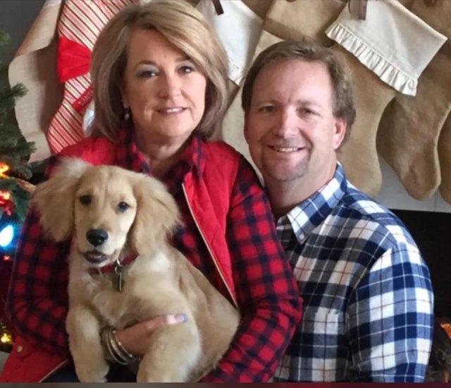 Denise and Mark with a Golden puppy
